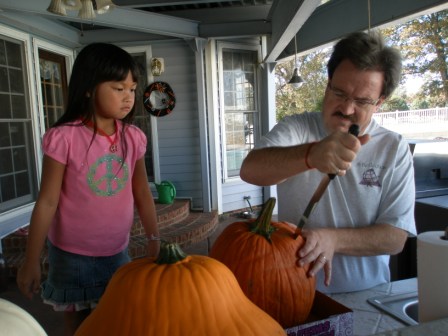 Kasen and Daddy carving a pumpkin